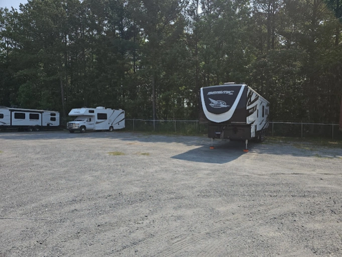 Outdoor RV storage in Marietta GA with motorhomes parked in a secure gravel lot near local lakes