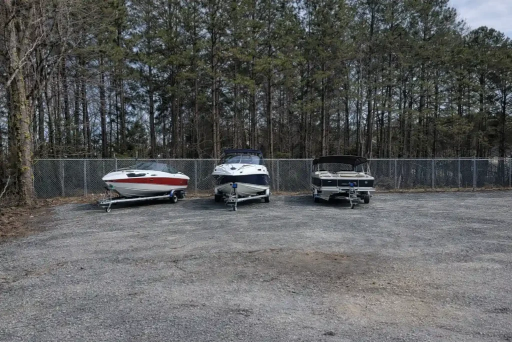 Boats stored on trailers in a secure outdoor storage lot in Marietta